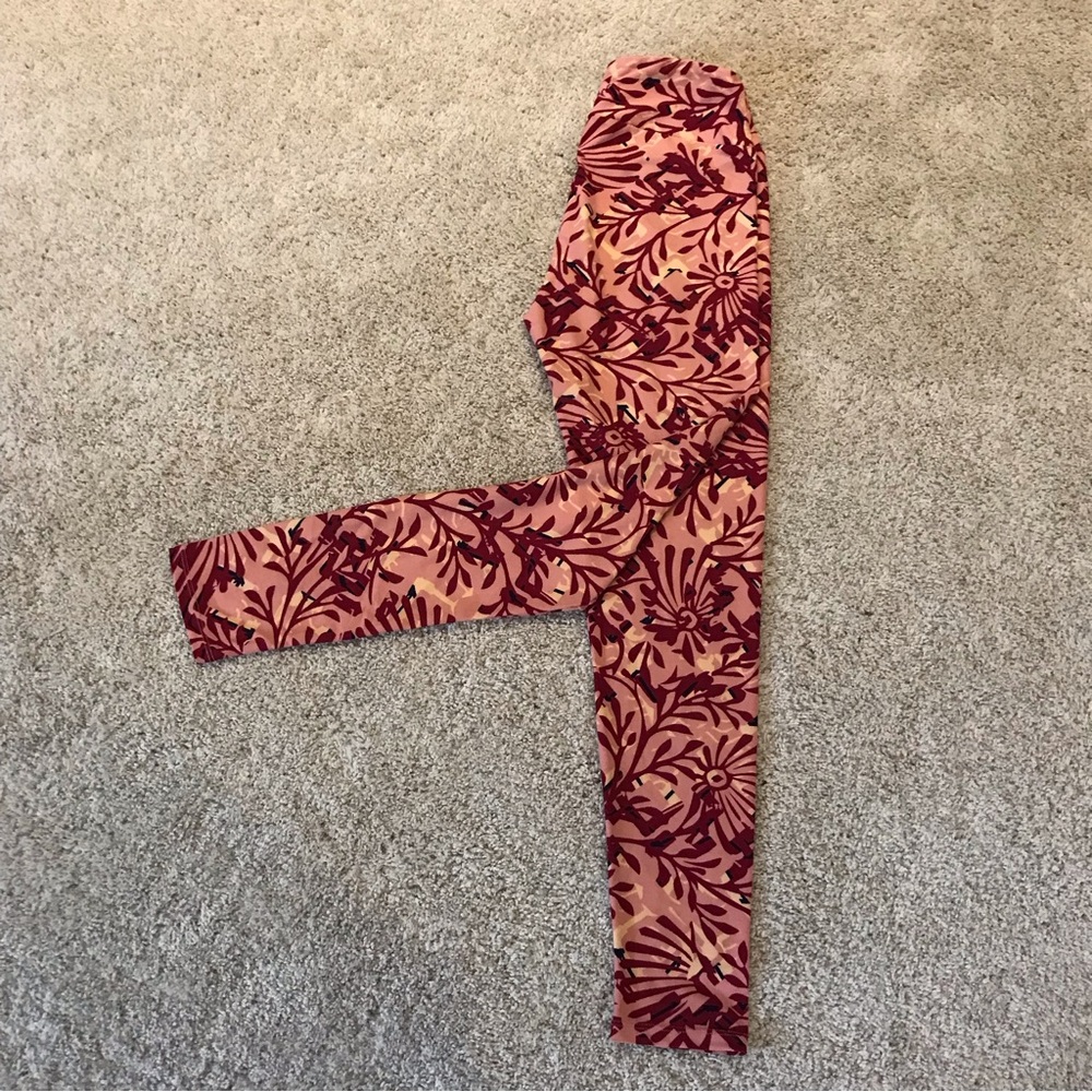LuLaRoe One Size Leggings in a colorful floral print of pink burgundy and cream.